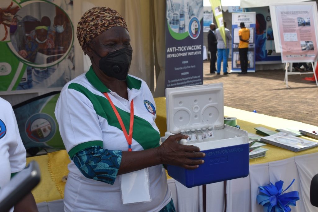 Dr. Margaret Saimo-Kahwa holding a batch of TicVac-U vaccine proteins